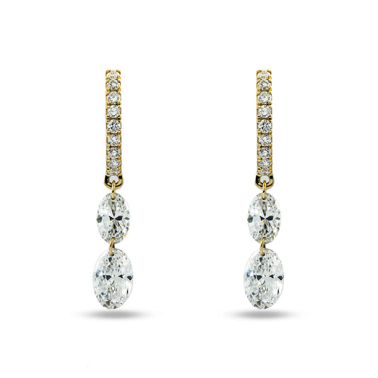 Gold and diamond earrings on a white background