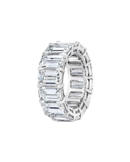 Diamond ring with emerald-cut stones on a white background