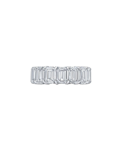 Diamond ring with emerald-cut stones on a white background