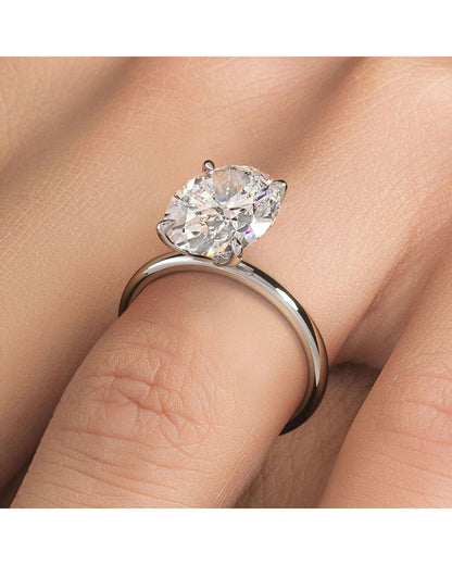 Diamond ring on a finger with a soft background