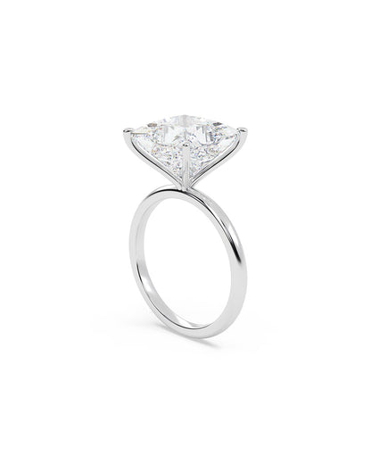 Diamond ring with a princess cut stone on a white background