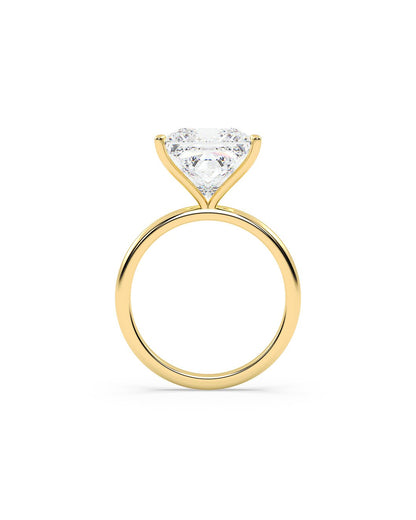 Yellow gold ring with a princess cut diamond on a white background
