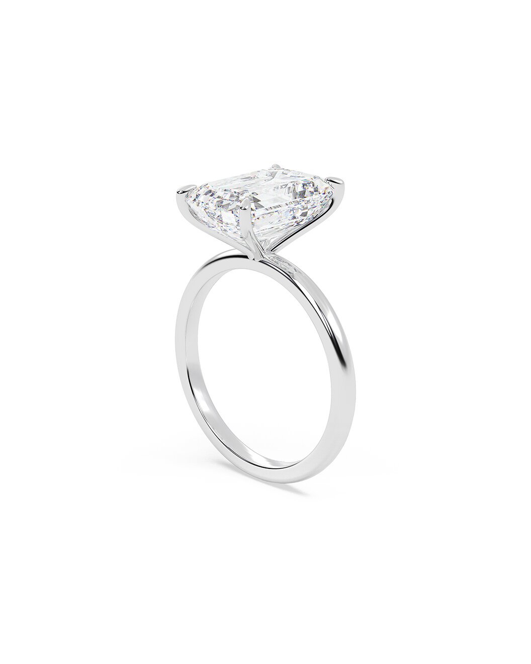 Diamond ring with an emerald diamond on a white background