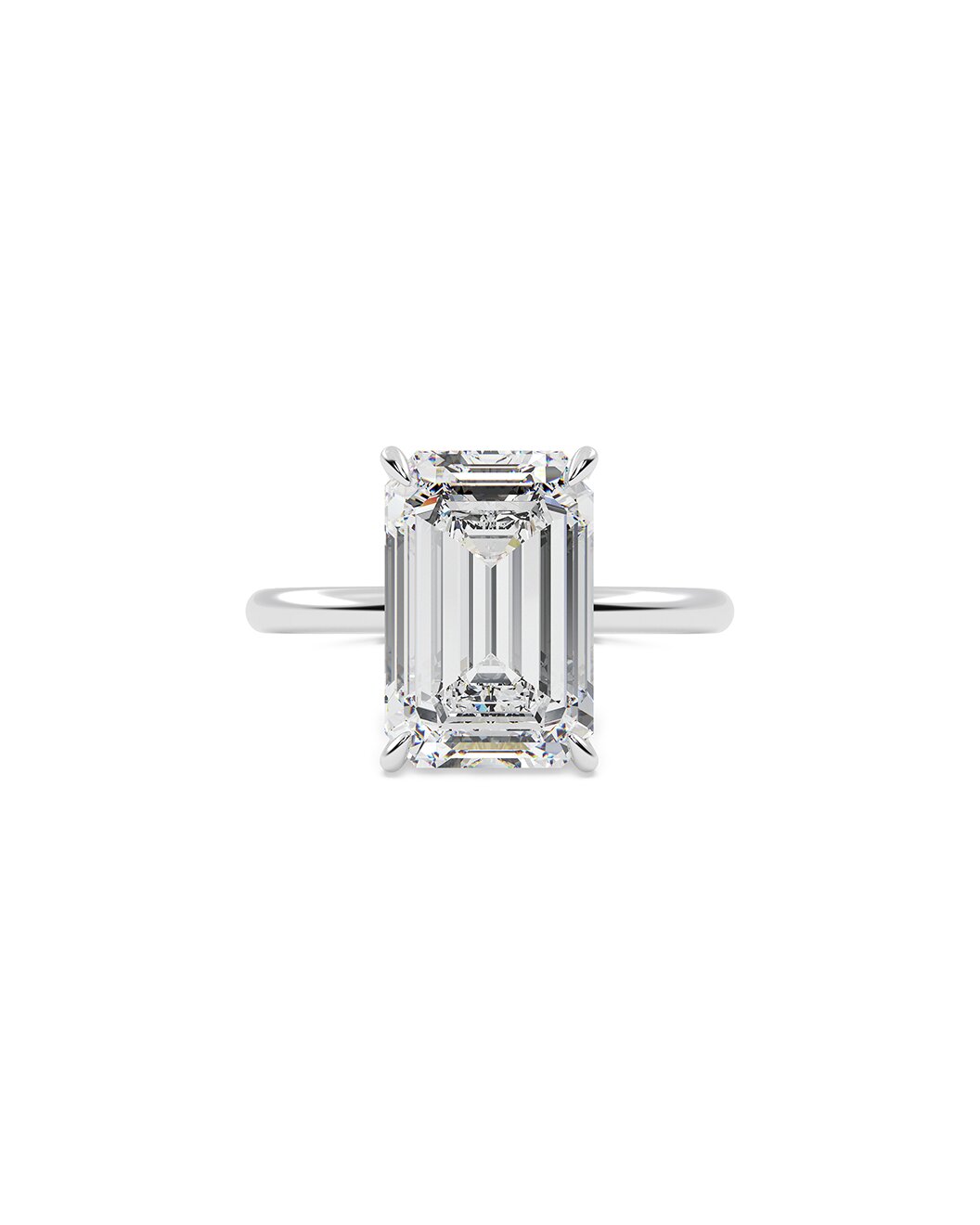 Diamond ring with emerald-cut stone on a white background