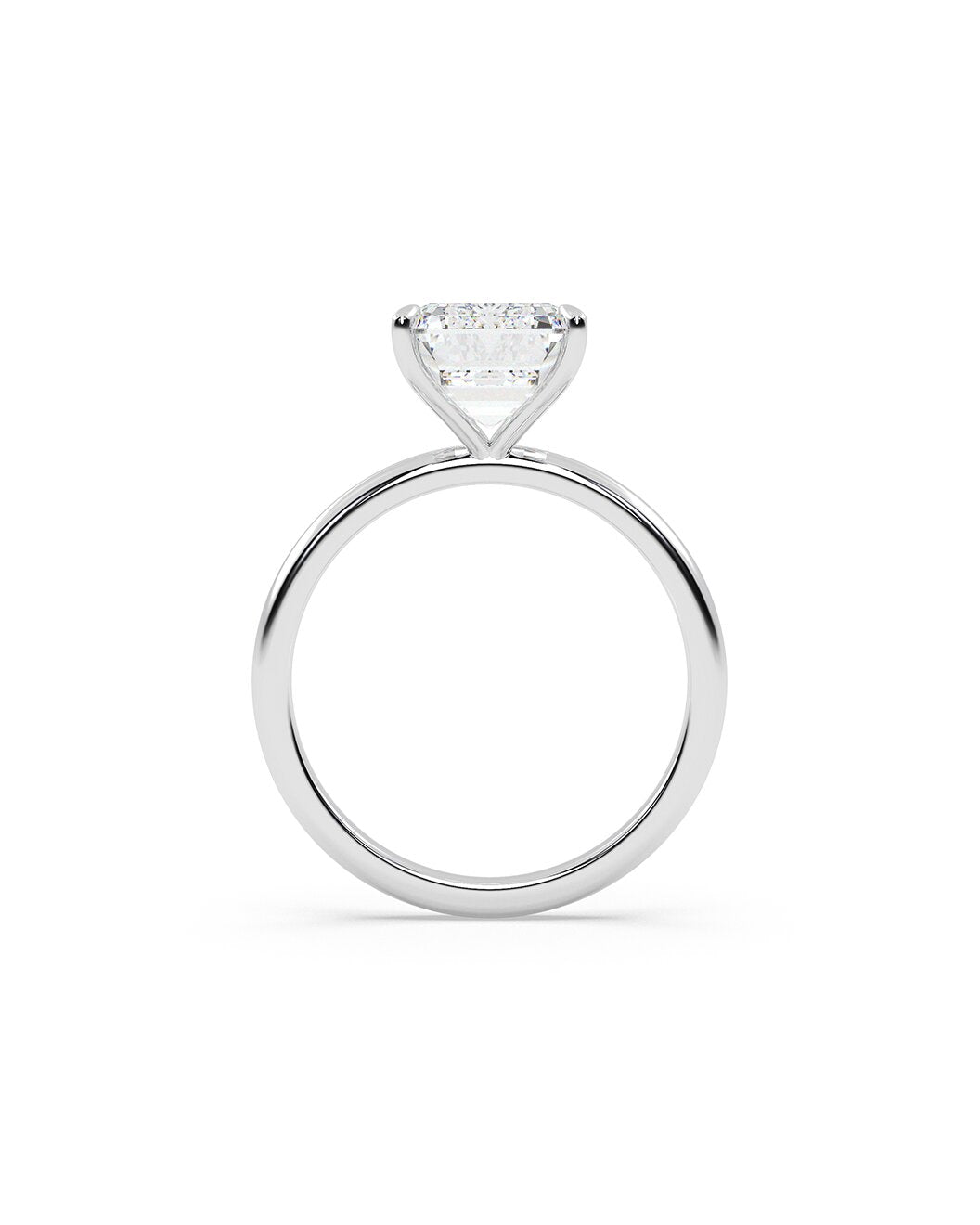 Diamond ring with a emerald-shaped gemstone on a white background