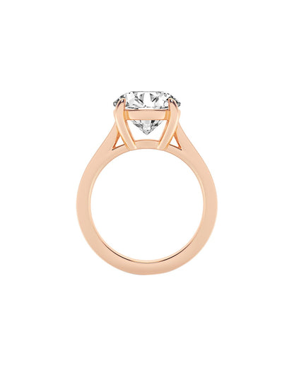 Rose gold ring with a clear gemstone on a white background side