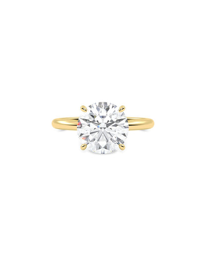Gold ring with a large diamond on a white background