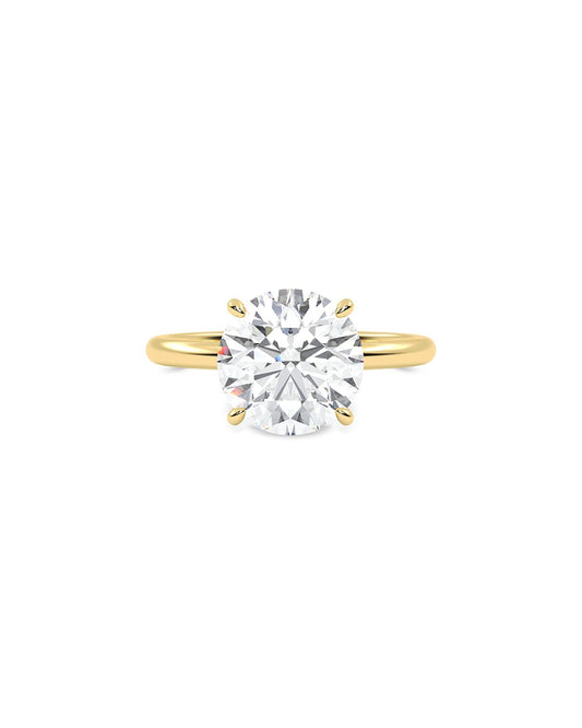 Gold ring with a large diamond on a white background