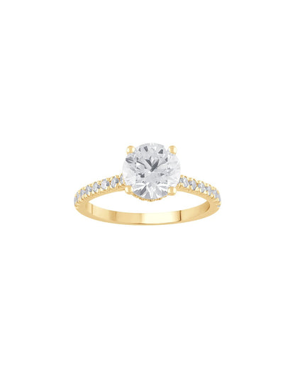 Gold ring with a large diamond and smaller diamonds on the band against a white background