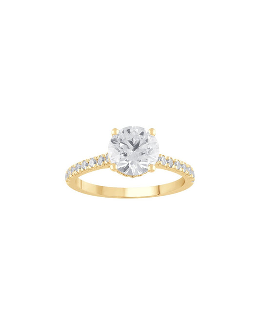 Gold ring with a large diamond and smaller diamonds on the band against a white background