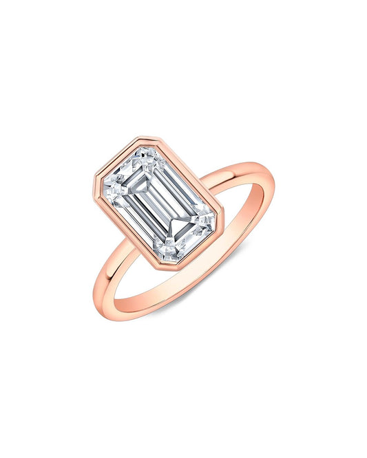 Rose gold ring with a large emerald-cut diamond on a white background