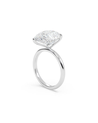 Diamond ring with a pear-cut diamond on a white background