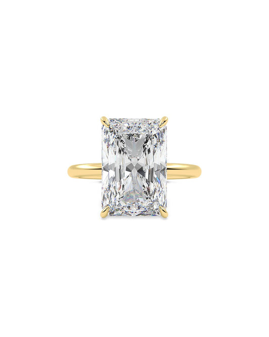 Gold ring with a large radiant diamond on a white background