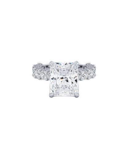 Diamond ring with a central princess-cut diamond and two smaller diamonds on a white background