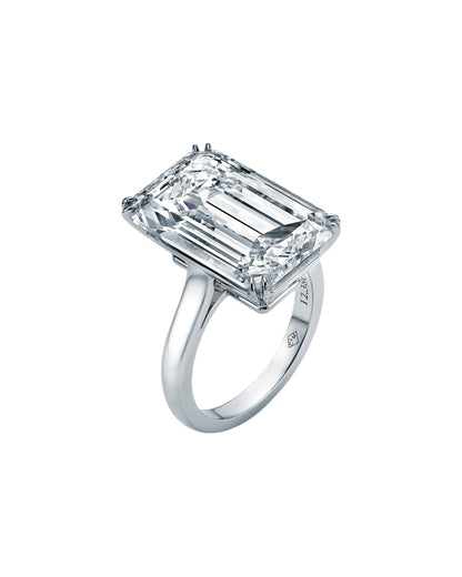 Diamond ring with emerald-cut diamond on a white background