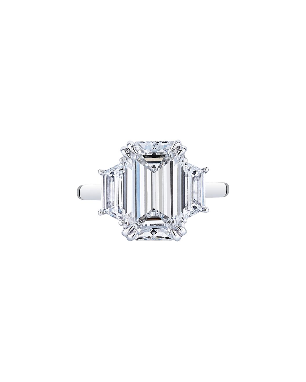 Diamond ring with emerald-cut stone on a white background