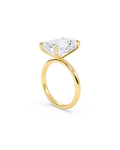 Yellow Gold ring with a large diamond on a white background