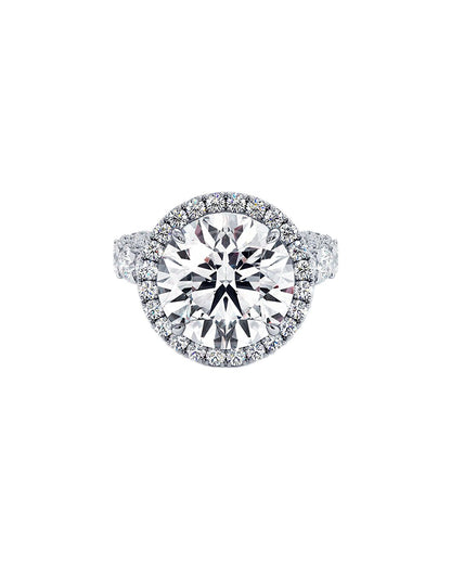 Diamond ring with a halo on a white background