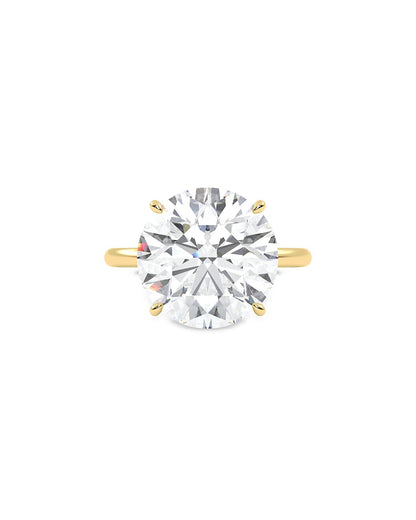 Yellow gold ring with a large diamond on a white background