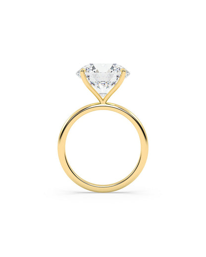 Yellow gold ring with a clear diamond on a white background