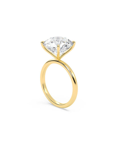 Yellow gold ring with a large diamond on a white background