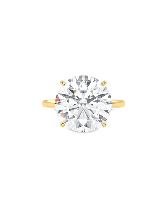 Yellow gold ring with a large diamond on a white background