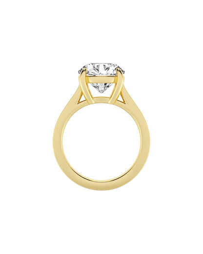Yellow gold ring with a diamond on a white background