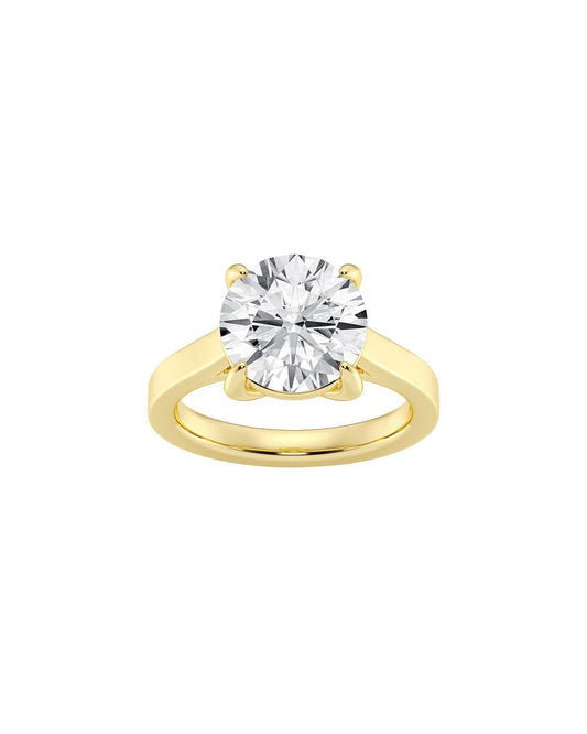 Yellow gold ring with a large diamond on a white background