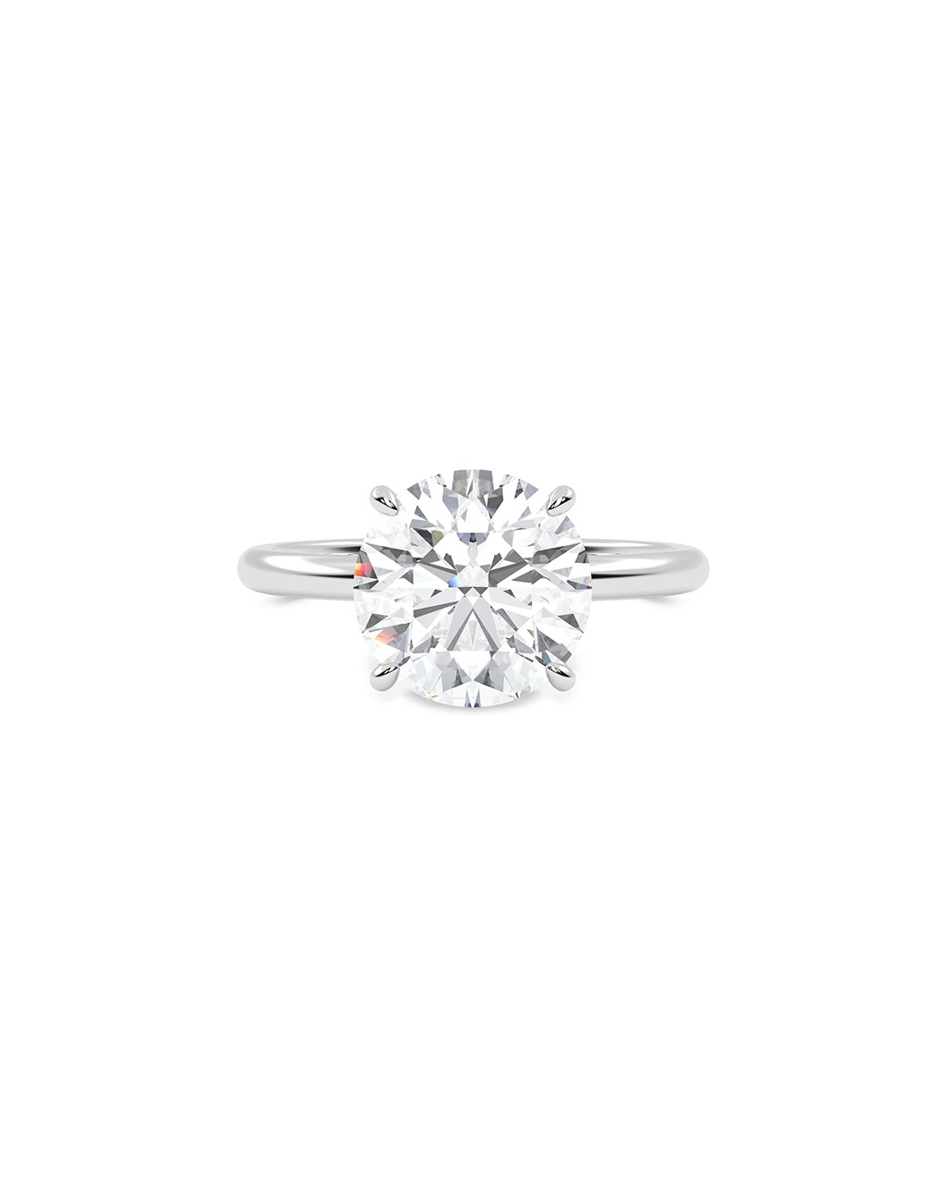Round cut diamond ring on a white background
