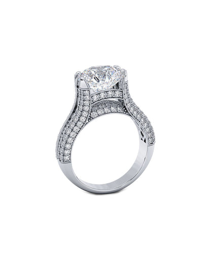 Diamond ring with a central round cut gemstone and smaller stones on a white background