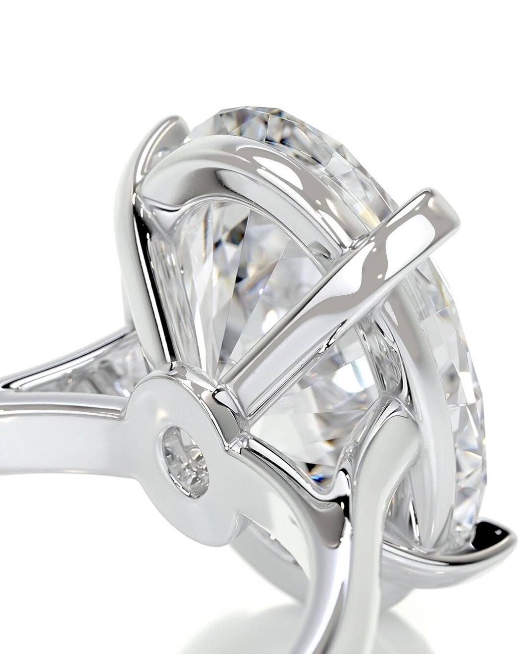 Close-up of a diamond ring with a clear gemstone and silver band on a white background