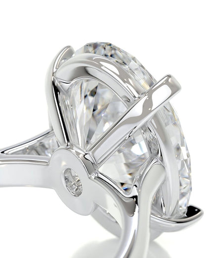 Close-up of a diamond ring with a clear gemstone and silver band on a white background