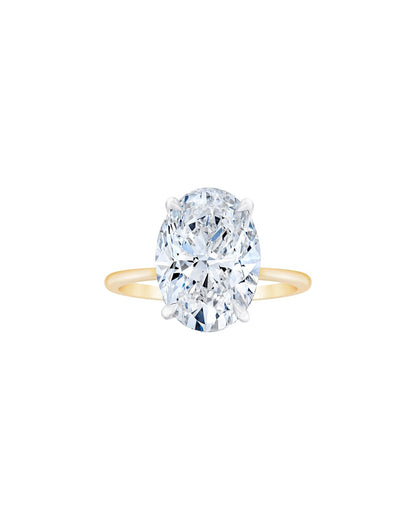 Yellow gold ring with a large diamond on a white background