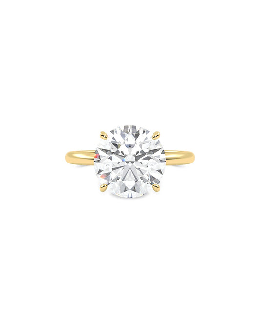 Gold ring with a large diamond on a white background