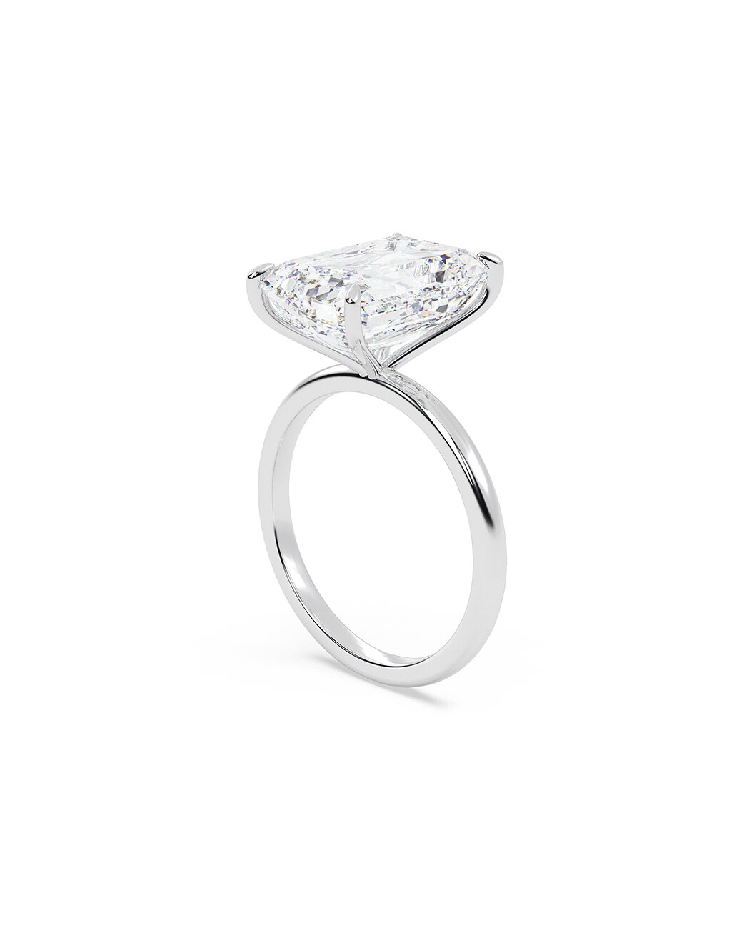 Diamond ring with an emerald cut stone on a white background