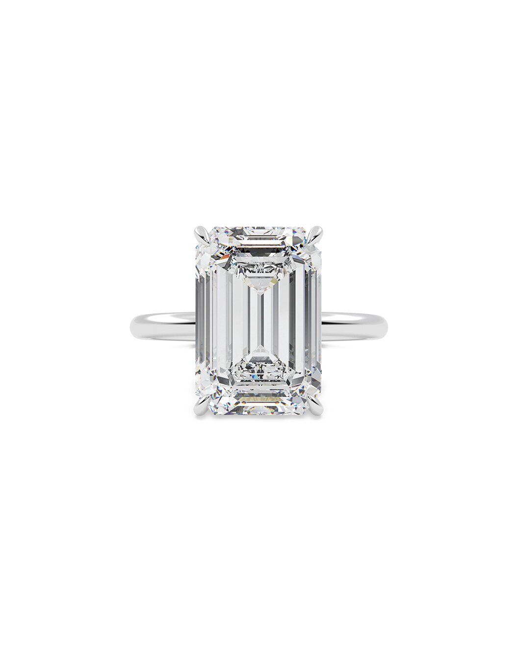Diamond ring with emerald-cut center stone on a white background