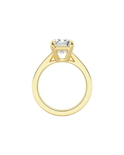 Yellow gold ring with a diamond on a white background