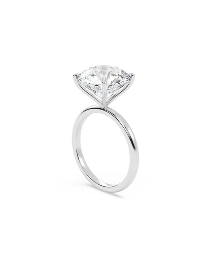 Diamond ring with a round cut diamond on a white background