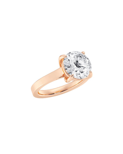 Rose gold ring with a large round cut diamond on a white background
