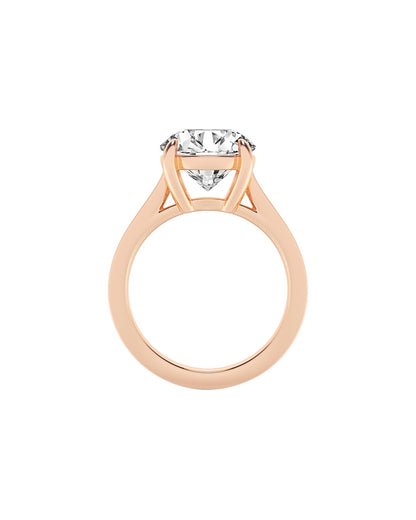 Rose gold ring with a round cut diamond on a white background