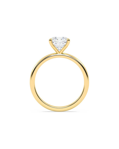 Gold ring with a cushion-shaped diamond on a white background
