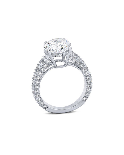 Diamond ring with a round cut diamond and smaller diamonds on a white background
