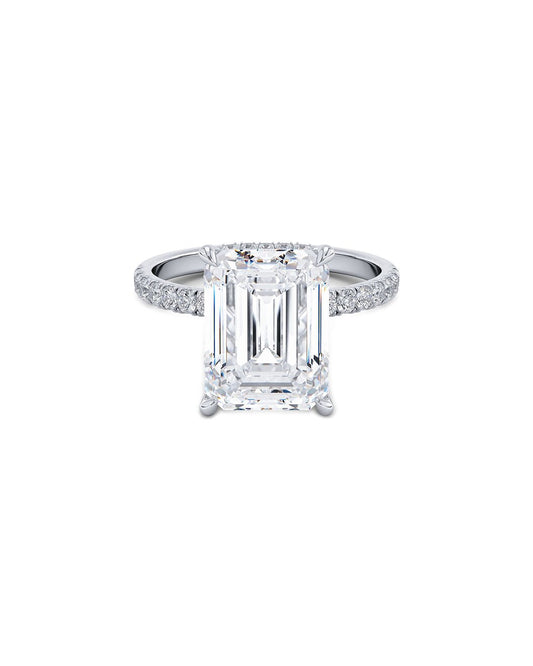 Diamond ring with emerald-cut center stone on a white background