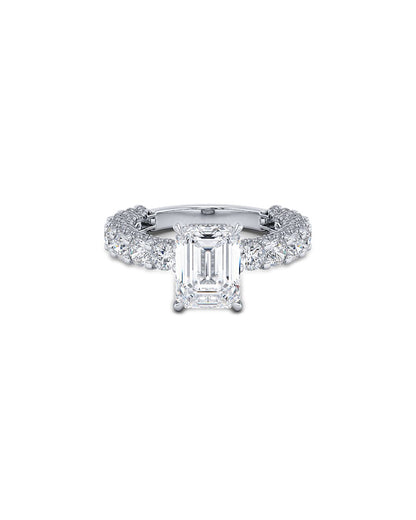 Diamond ring with emerald-cut center stone on a white background