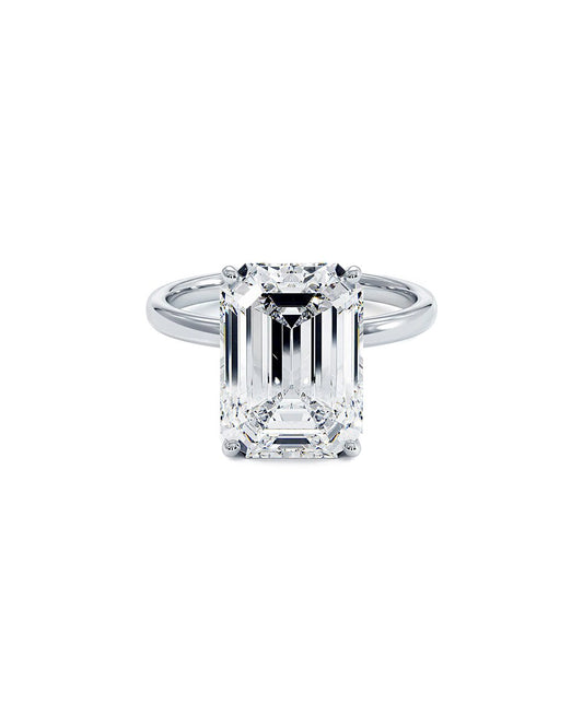 Diamond ring with emerald-cut diamond on a white background