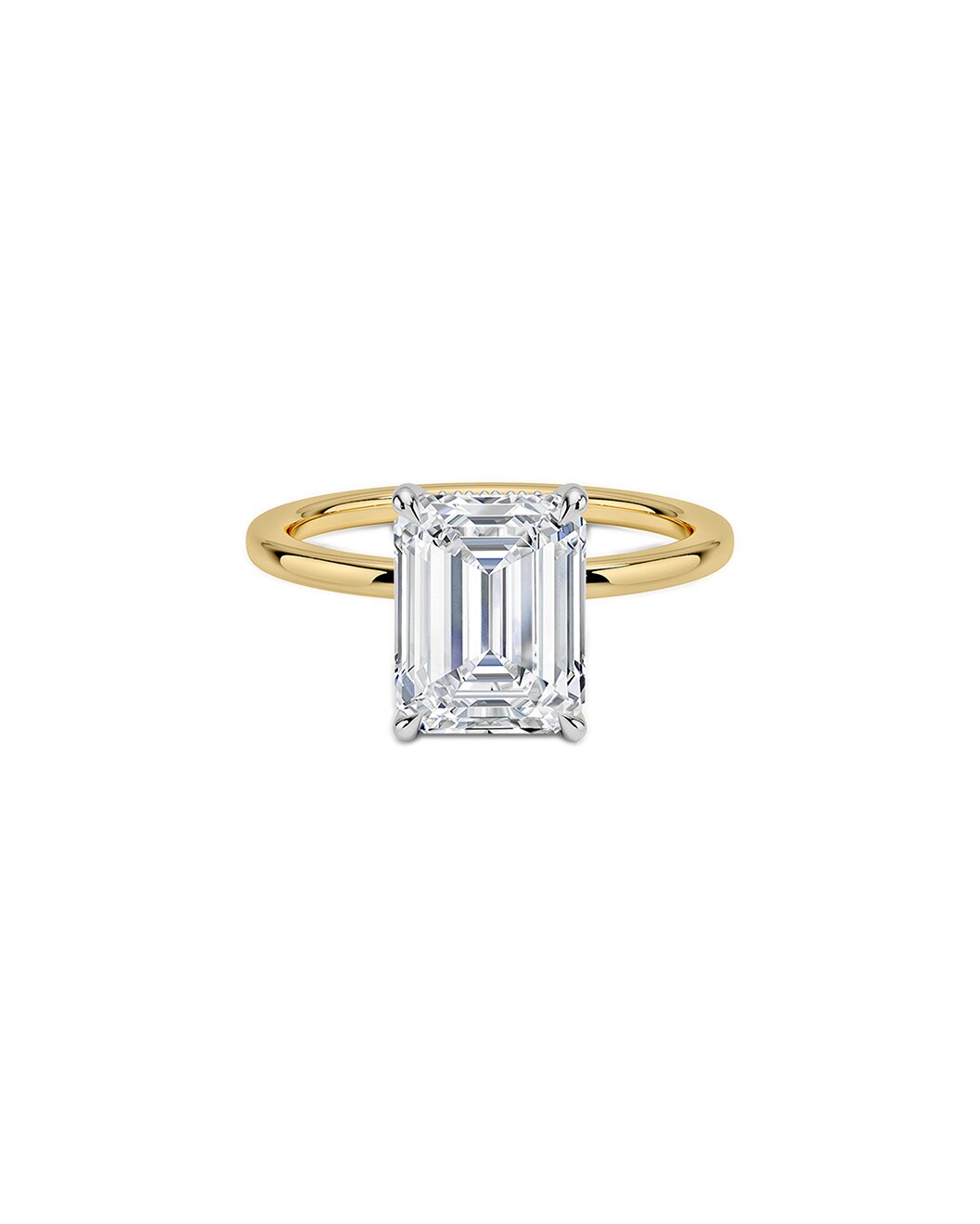 Yellow gold ring with an emerald cut diamond on a white background