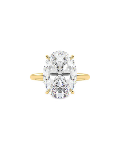 Yellow Gold ring with a large oval cut diamond on a white background