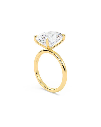 Yellow gold ring with a large diamond on a white background
