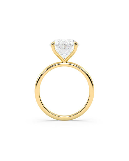 Yellow gold ring with a oval cut diamond on a white background