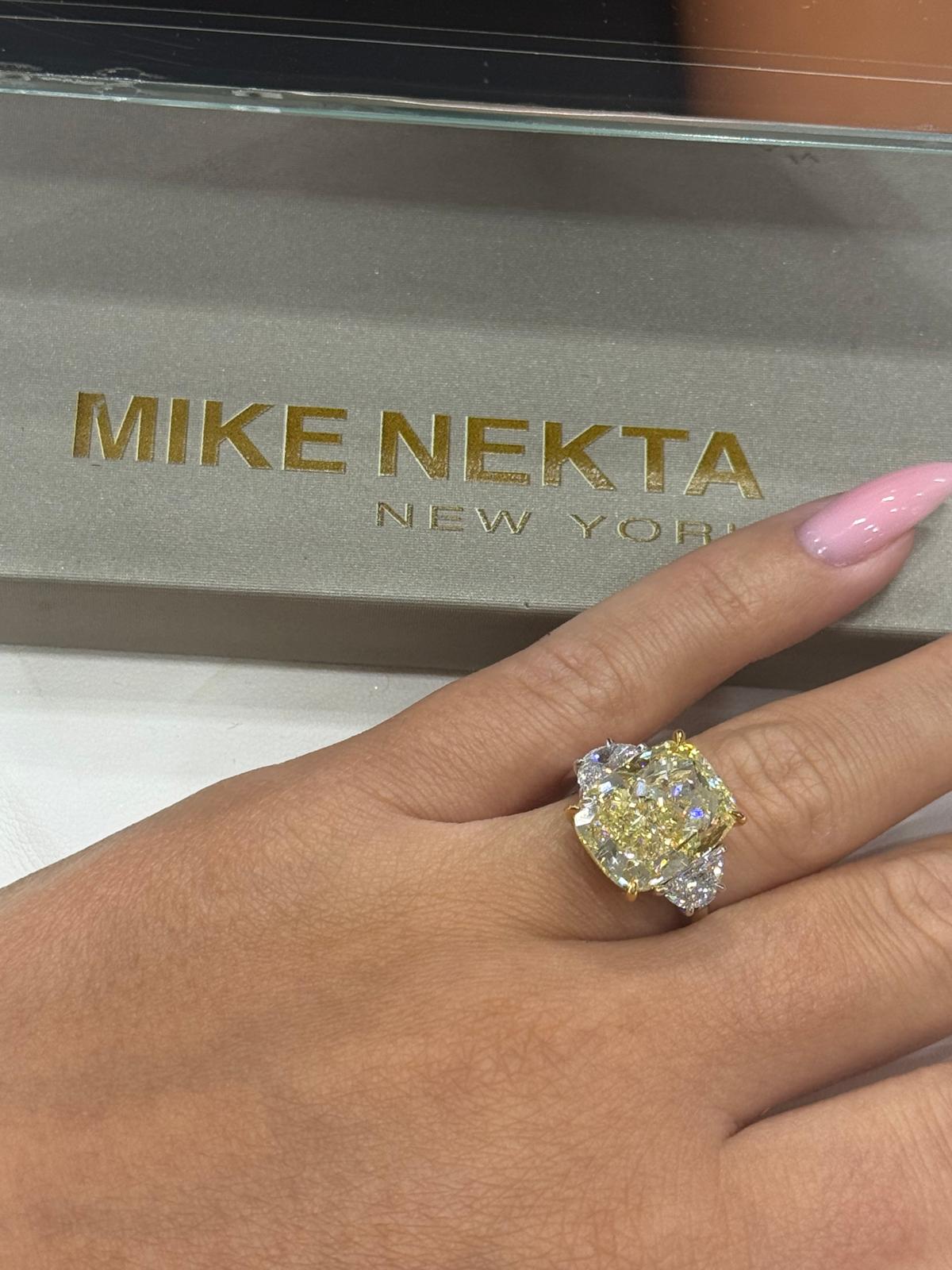 Diamond ring on a hand with 'MIKE NEKTA NEW YORK' brand box in the background